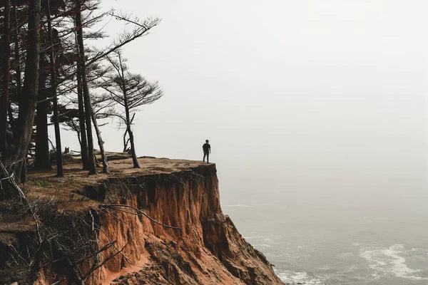 Man standing on the edge of a cliff.